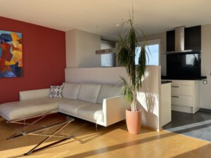 Beautiful corner couch in sunny living room in furnished flat in Munich
