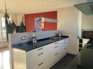 Open-plan kitchen with plenty of storage space in furnished flat in Munich
