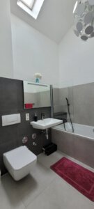 Modern bathroom with window in furnished apartment in Munich West