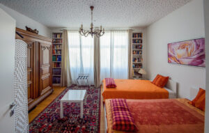 Practical bedroom with two large beds in a furnished flat in Munich